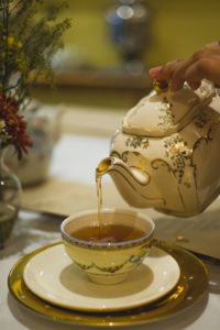 person pouring tea